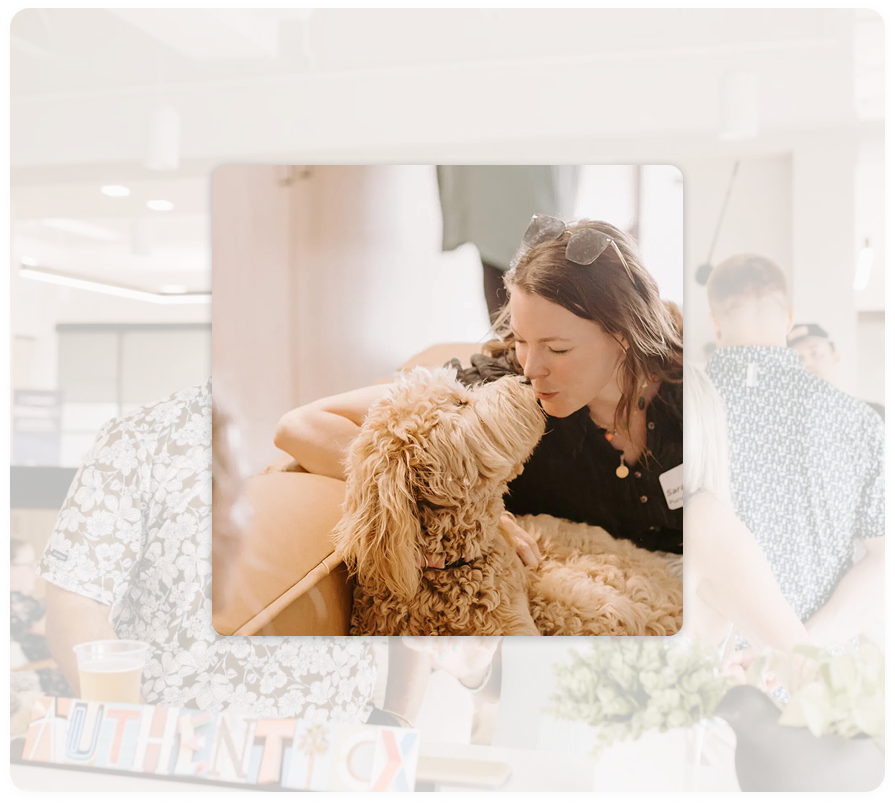 An Authenticx team member with a dog in a pet-friendly office, with an Authenticx sign in the background and a purple-to-teal gradient frame